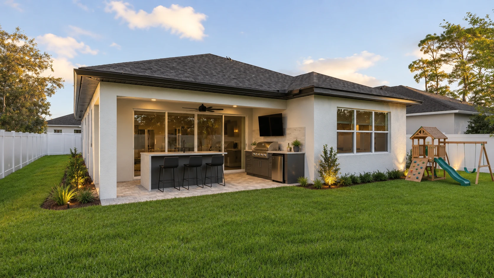 Covered lanai with outdoor kitchen and bar seating after renovation by SAVAM House