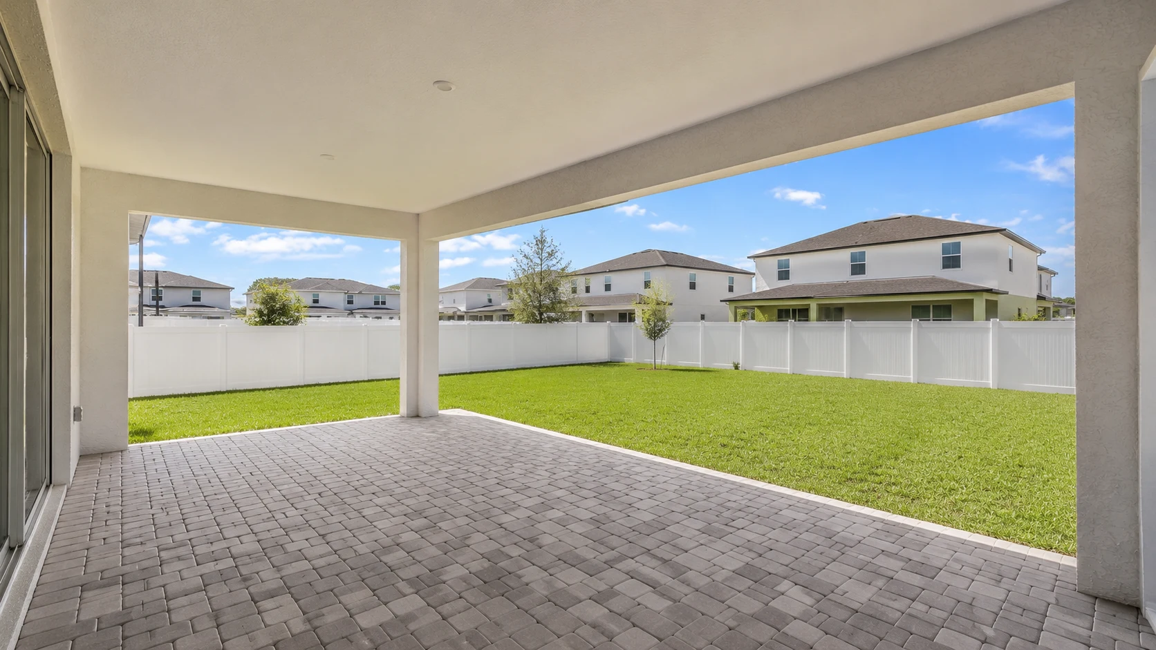 Bare covered patio shell with no furniture or finishes before renovation